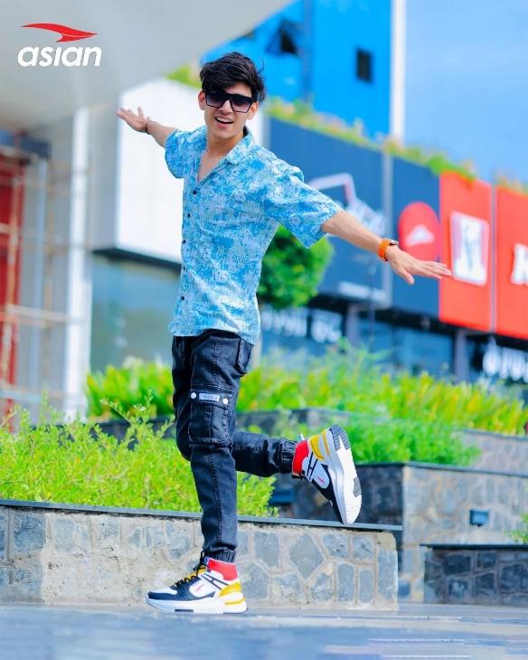 Model posing happily in high top sneakers.